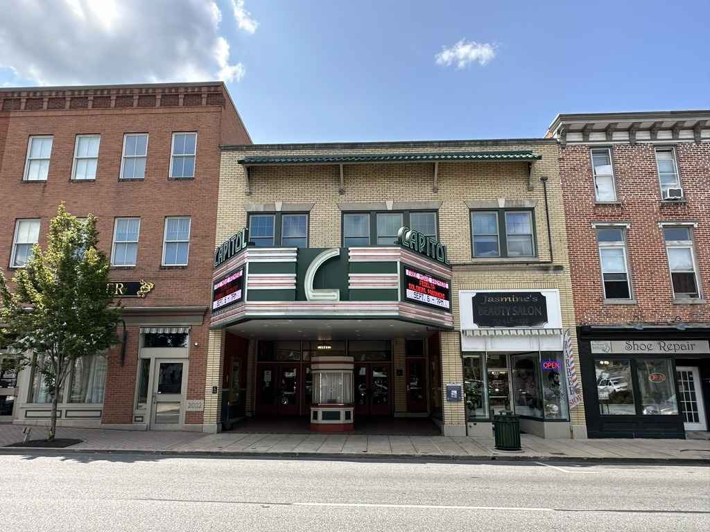 Front facade of the Capitol Theatre in Franklin County, Pennsylvania, featuring a retro marquee and neighboring storefronts.