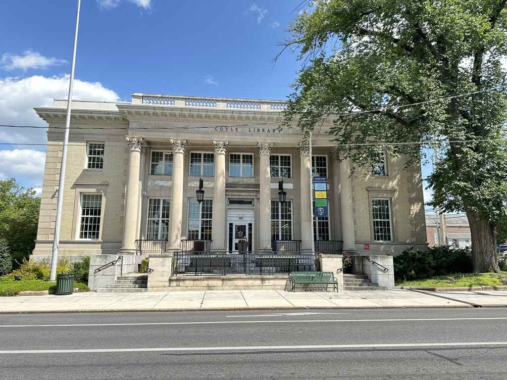 Exterior of the Coyle Free Library in Franklin County, a historic building with grand columns and a modernized entrance.