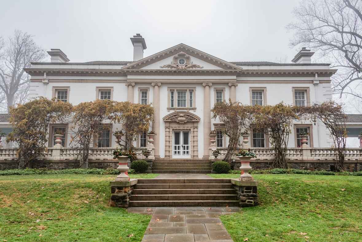 A grand historic mansion called the Bel Air Mansion with intricate architectural details and a foggy backdrop, located in Harford County, Maryland.