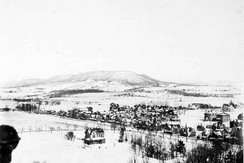 A wintertime view of Mount Nittany and the surrounding valley in Centre County, with snow-covered fields and distant mountains.