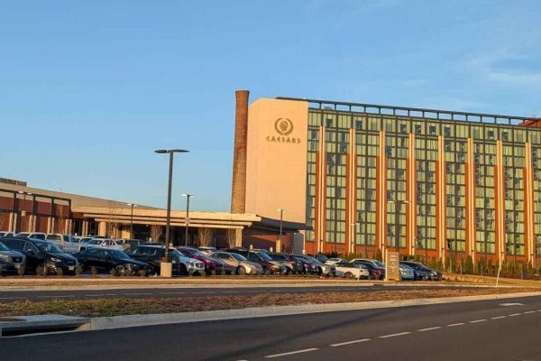Caesars Casino in Danville, Virginia, showing a modern gaming and hotel complex with a large parking lot and contemporary architectural design.