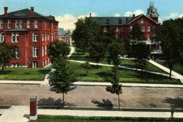 Vintage postcard showing the Juniata College campus in Huntingdon County, Pennsylvania, featuring red-brick academic buildings surrounded by trees and pathways.