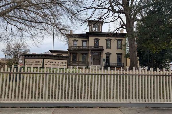 Danville Museum of Fine Arts and History, housed in a historic antebellum mansion with a beige facade, black shutters, and a surrounding white picket fence.