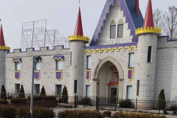 Dutch Wonderland Amusement Park in Lancaster County, Pennsylvania, featuring a medieval castle-themed entrance with stone walls, red and yellow turrets, and decorative banners.